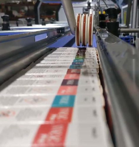 Three conveyors make multiple wrap formats possible on e-cigarette shrink-wrapping line